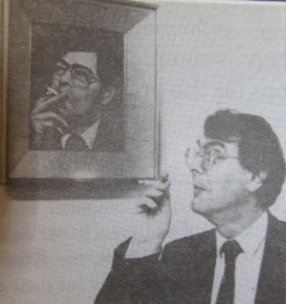 0013 : Mike posing with a portrait of Alan Dukes in Newcastle West Library.