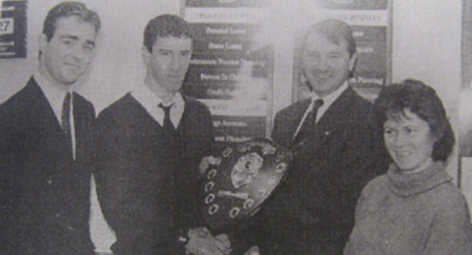 0163 : 1995 Aogán O'Maolcatha, Student of the Year at Gaelcholáiste Uí Chonbá pictured receiving the Bank of Ireland Shield from Eamon Mellett, Branch Manager, Newcastle West. Also in picture are David Lucey, Student Officer and Siobhán Ní Chonchúir, School Principal.