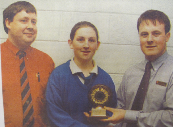 0174 : Clár Ní Ghiolla-Phádraig, winner of the Lady of the Match Award with Brian O'Sullivan AIB and teacher Dónal Enright.